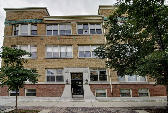 Front view of a three-story brick apartment building