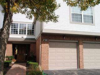 Front view of a two-story house with double garage doors.