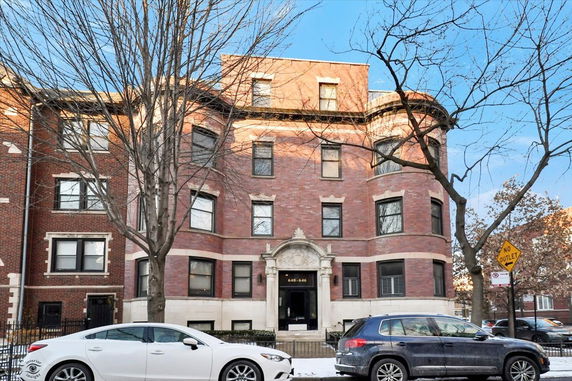 Front view of a multi-story brick apartment building.