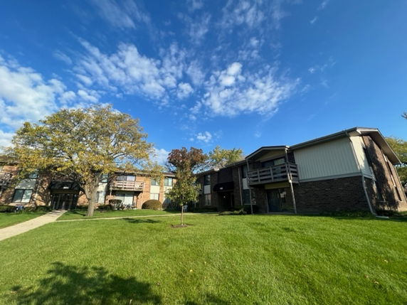 Front view of a multi-unit residential building with balconies.