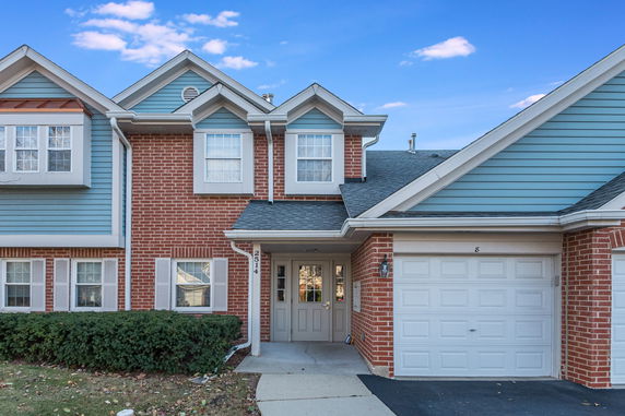 Front view of a two-story house with a garage.