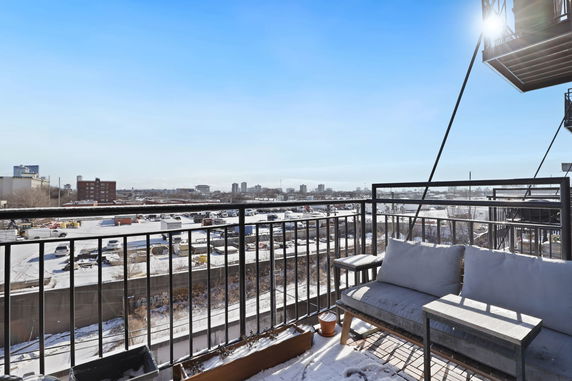 Balcony view overlooking a snow-covered urban area.