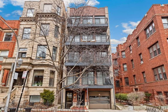Front view of a multi-story residential building with balconies.