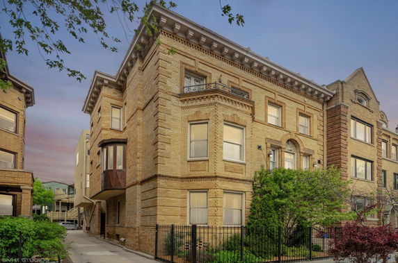 Front view of a multi-story brick apartment building.