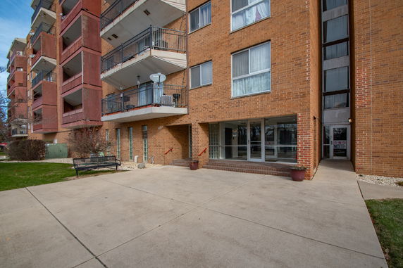 Front view of a multi-story apartment building with balconies.