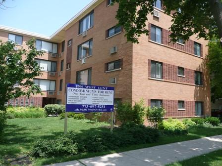 Front view of a multi-story brick condominium building.