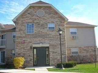Front view of a two-story brick and siding building.