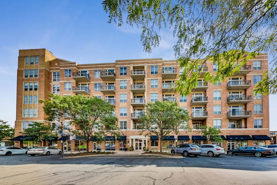 Front view of a multi-story apartment building with balconies.