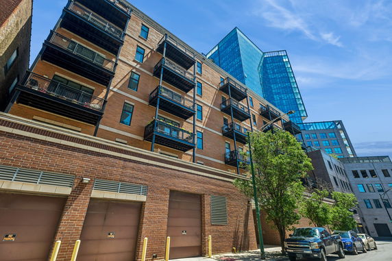 Front view of a multi-story brick building with balconies.
