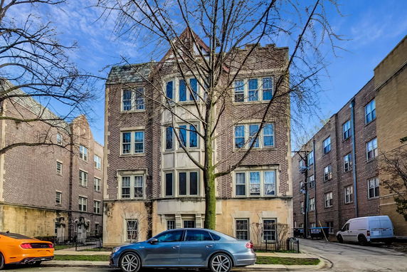 Front view of a multi-story brick building with numerous windows.