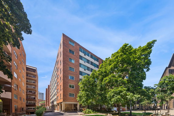 Front view of a multi-story brick apartment building.