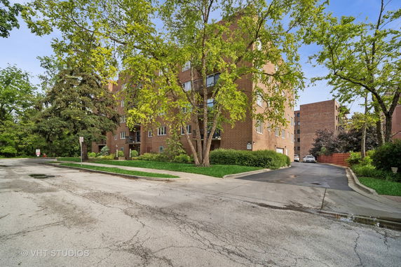 Front view of a multi-story brick building with multiple windows.