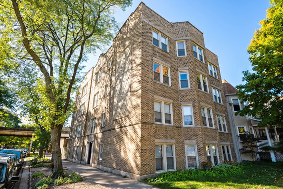 Front view of a multi-story brick apartment building.