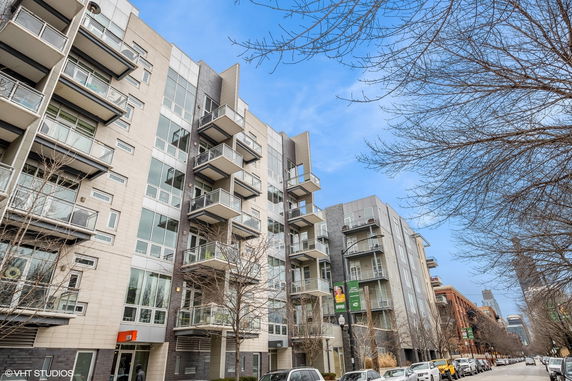Front view of a multi-story residential building with balconies.