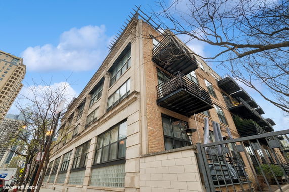 Front view of a multi-story brick building with balconies.