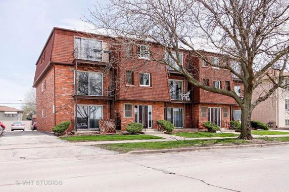 Front view of a multi-story brick residential building