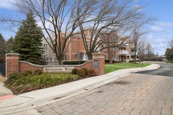 Front view of a multi-story brick building with balconies.