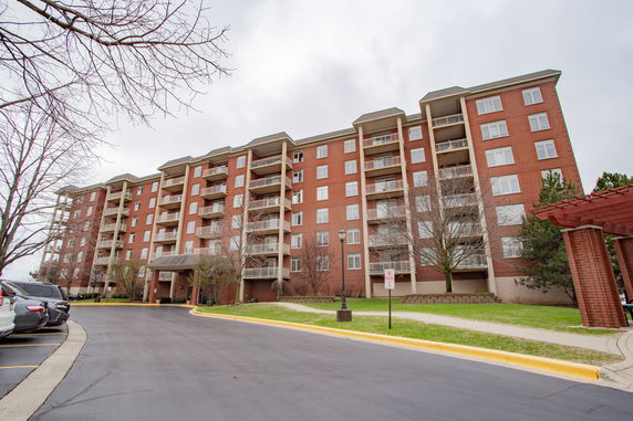 Front view of a multi-story apartment building with balconies.