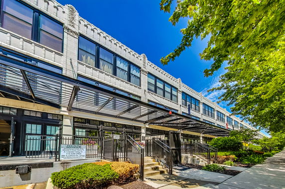 Front view of a two-story commercial building with large windows and a decorative facade.