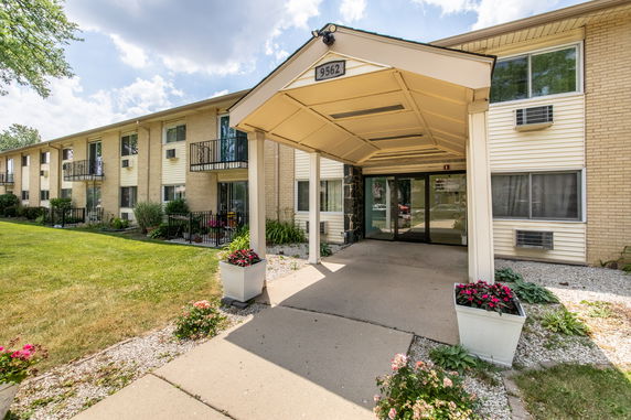 Front view of a two-story apartment building with a covered entrance.