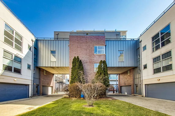 Front view of a modern multi-story building with a brick and metal facade.