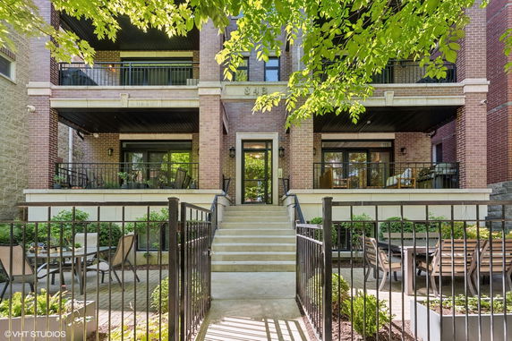 Front view of a multi-story brick building with balconies.