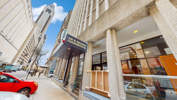 Front view of a multi-story condominium building entrance.