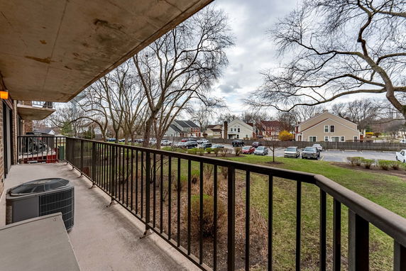 Panoramic view from a balcony overlooking surrounding residential area.