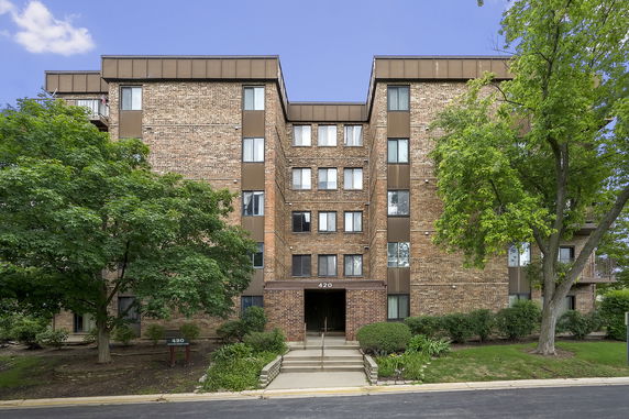 Front view of a multi-story brick apartment building.