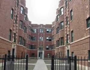 Front view of a multi-story brick building with a central entrance.
