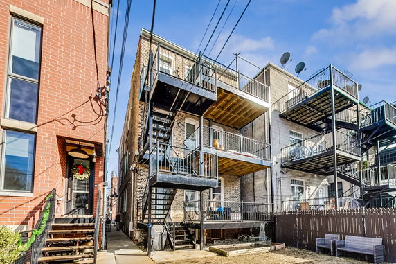 Side view of a multi-story residential building with external balconies.