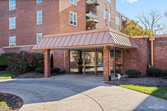 Front view of a brick building with a covered entrance.