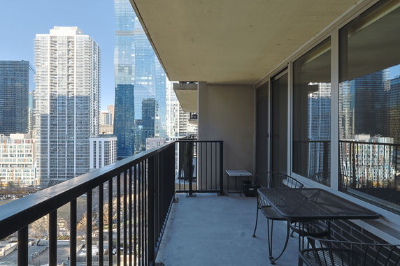 Balcony view of surrounding city buildings from a high-rise apartment.