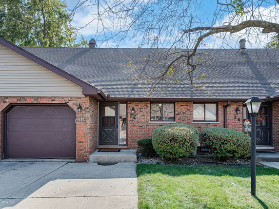 Front view of a single-story brick house with an attached garage.