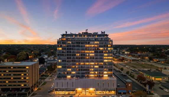 Front view of a multi-story building at sunset.