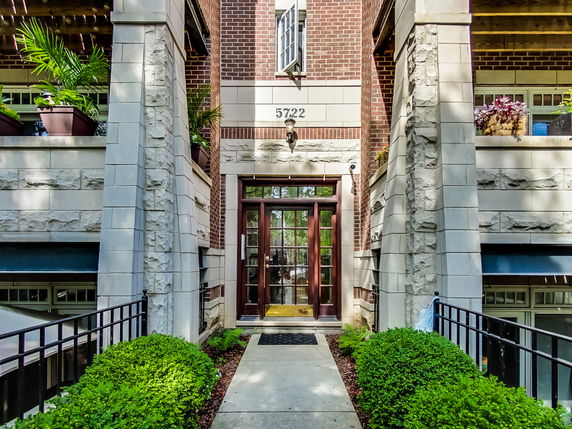 Front view of a multi-story building with brick and stone facade.