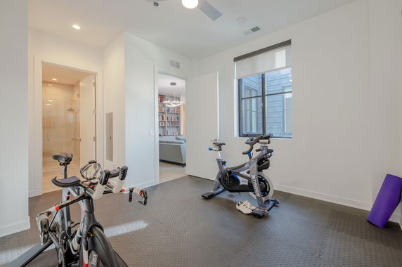 Indoor area with exercise bikes and workout equipment.