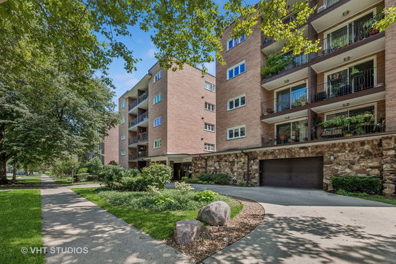 Front view of a multi-story apartment building with balconies.