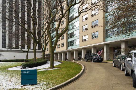 Front view of a multi-story building with a driveway entrance.