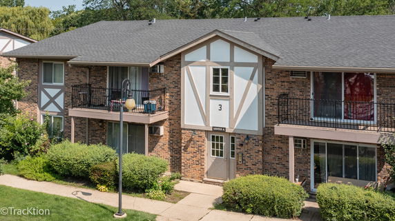 Front view of a two-story brick building with balconies.