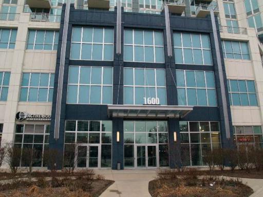 Front view of a multi-story building with large glass windows and a prominent entrance canopy.