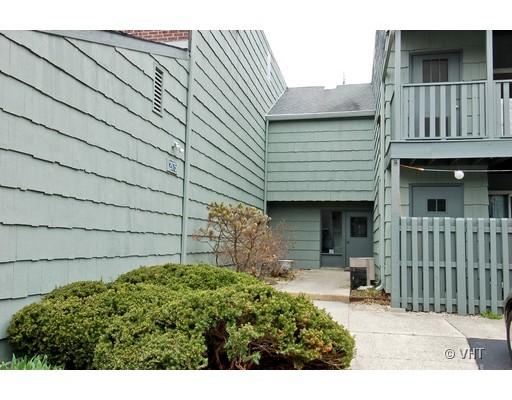 Front view of a building with wooden siding and balconies.