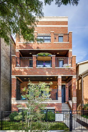 Front view of a multi-story brick building with balconies.