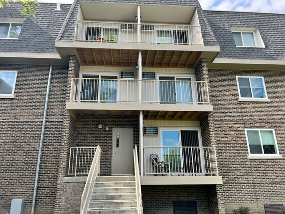 Front view of a multi-story building with balconies.