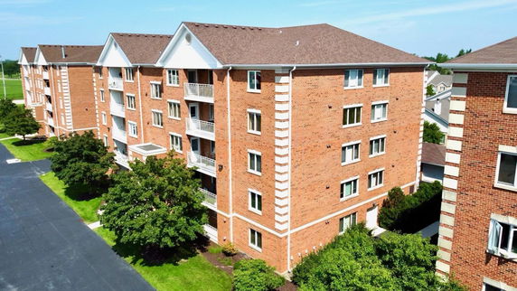 Front view of a multi-story brick apartment building.