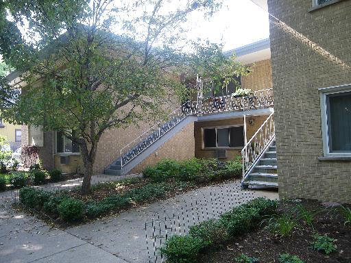 Front view of a multi-story building with outdoor stairs.