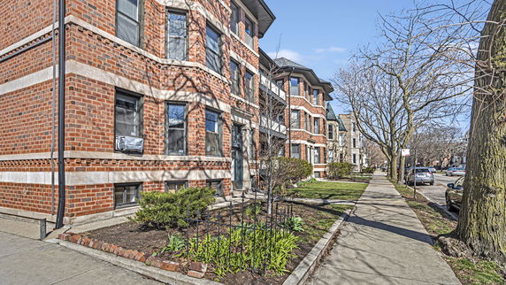 Front view of a three-story brick apartment building.