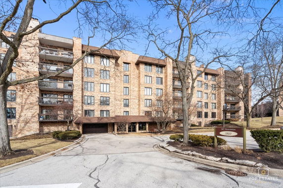 Front view of a multi-story brick apartment building.