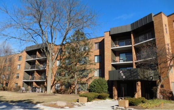 Front view of a multi-story apartment building with balconies.