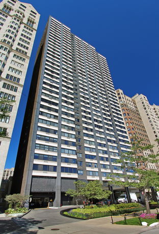 Front view of a tall, modern residential building with multiple windows.